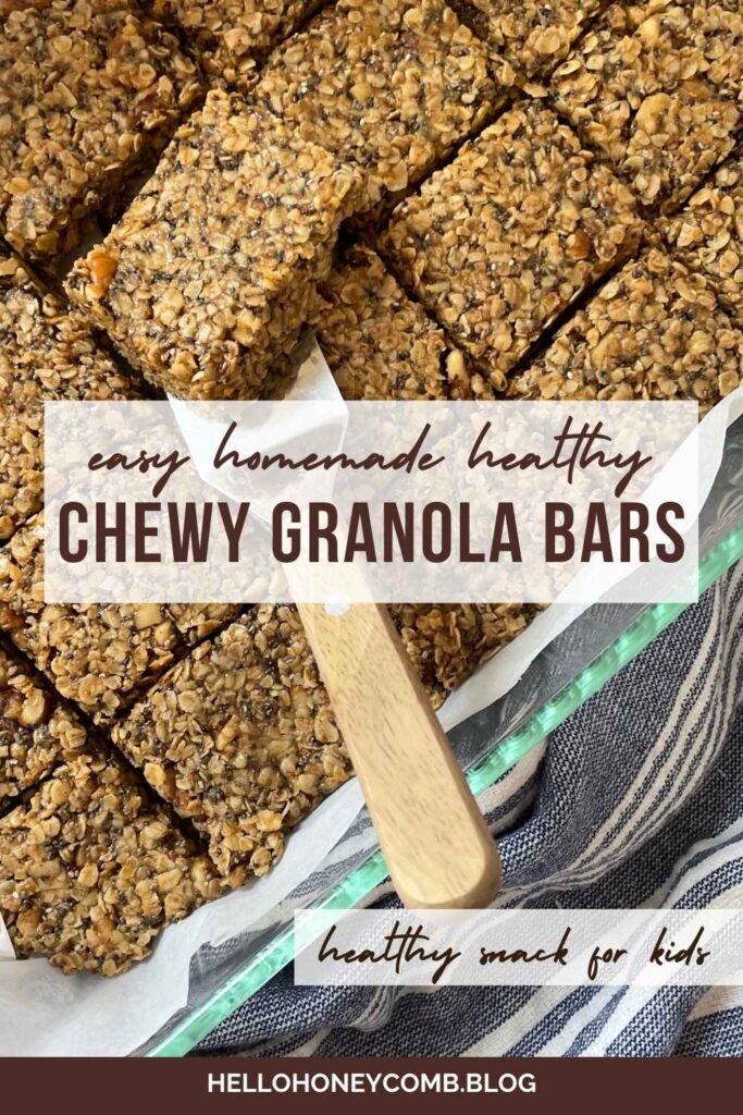 Homemade chewy granola bars in pan lined with parchment paper, one granola bar being lifted out by server with wooden handle with text overlaid that reads Easy Homemade Healthy Chewy Granola Bars, healthy snack for kids