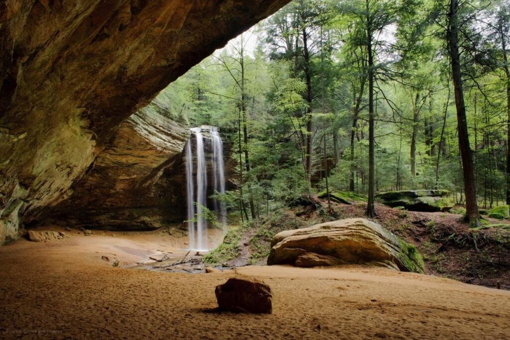 Ash Cave waterfall spilling over rocks into cave in Hocking Hills Ohio