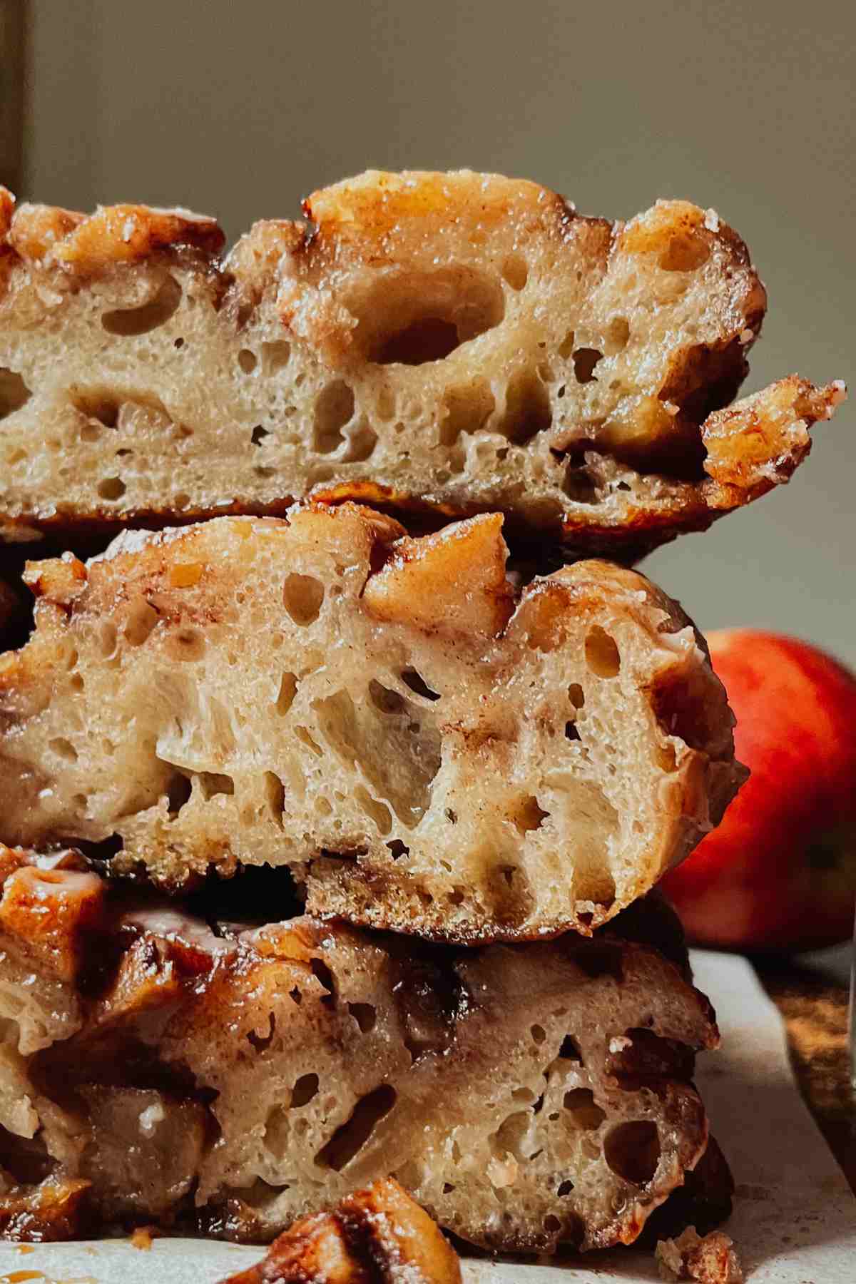 3 slices of sourdough apple fritter focaccia stacked on top of each other