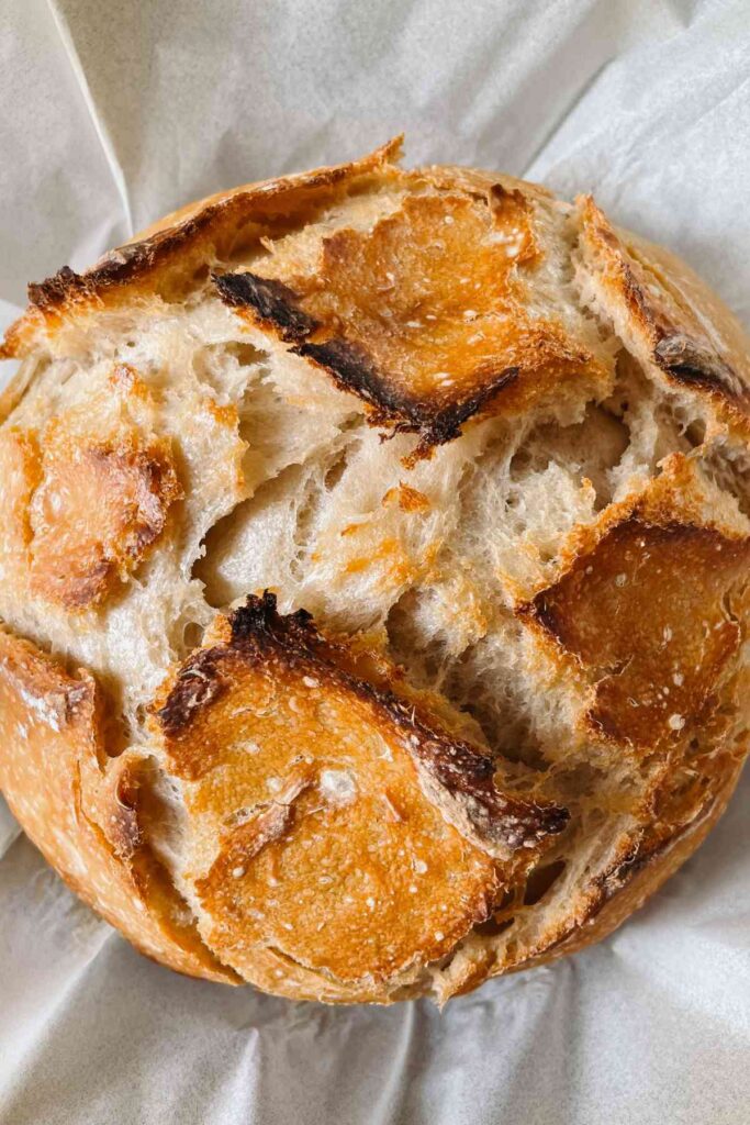 Unloaf sourdough bread loaf sitting on parchment paper