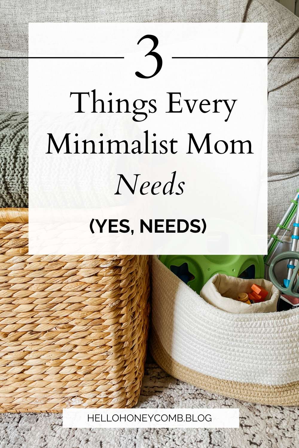 White basket filled with toys sitting next to a tan wicker basket with a green blanket visible on top next to a cream colored couch with text overlaid that reads 3 Things Every Minimalist Mom Needs (Yes, Needs)