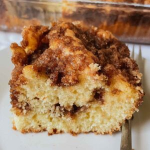 Sourdough discard coffee cake slice with fluffy sourdough coffee cake filled with cinnamon sugar crumble filling and topped with cinnamon sugar mixture