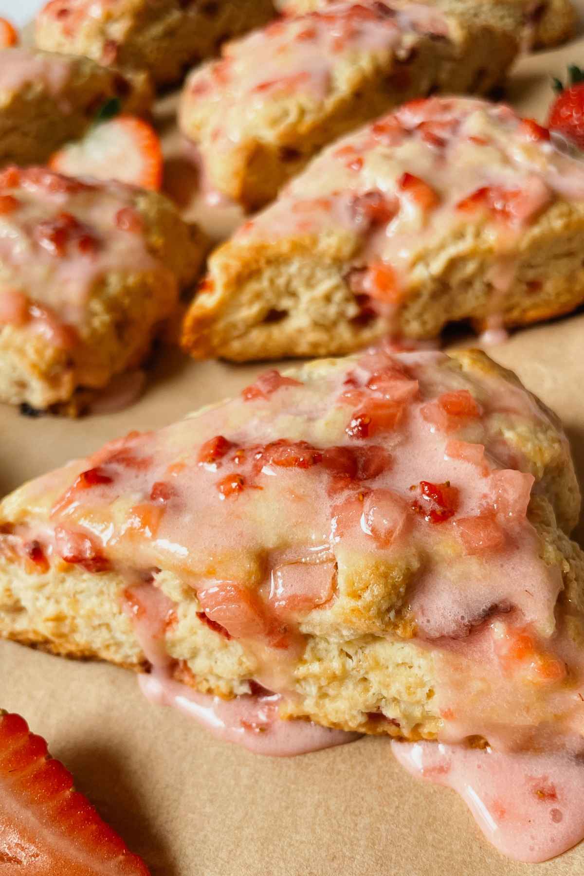 Close up of a sourdough strawberry scones drizzled with strawberry glaze