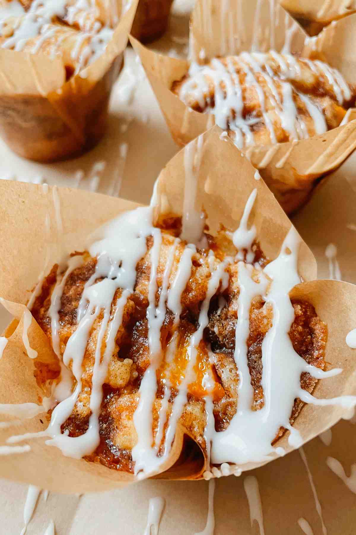 Sourdough peach coffee cake muffin drizzled with vanilla glaze