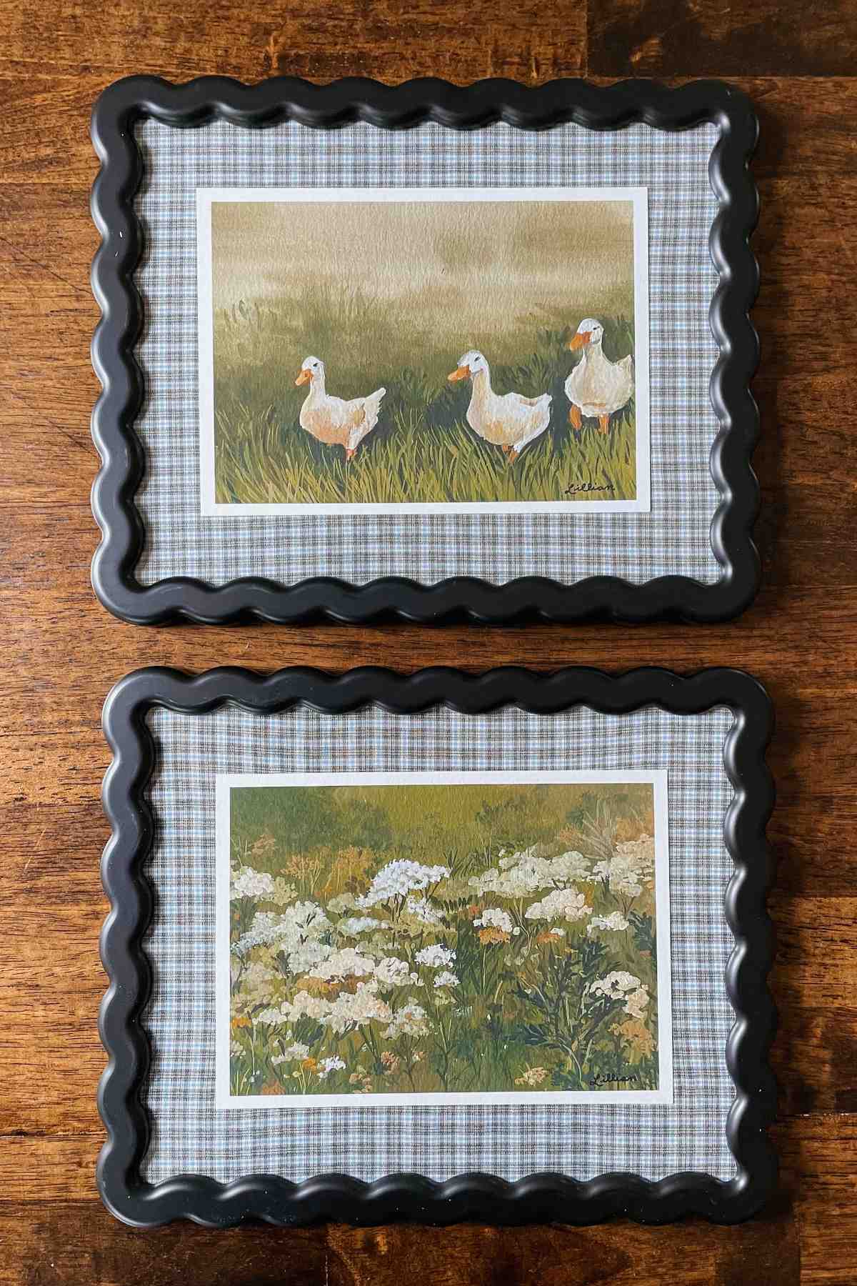 Black wavy picture frames with plaid fabric picture frame mats and art print of ducks and wildflowers