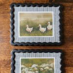 Black wavy picture frames with plaid fabric picture frame mats and art print of ducks and wildflowers