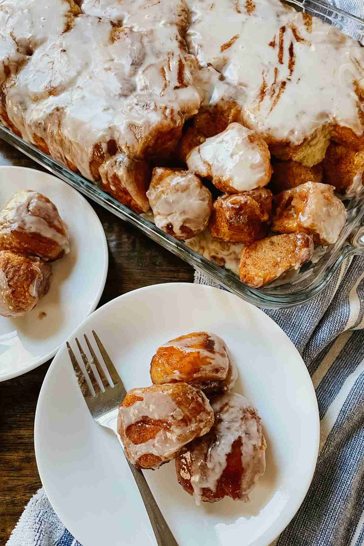 Sourdough brown butter monkey bread in pan and on white plate with a fork
