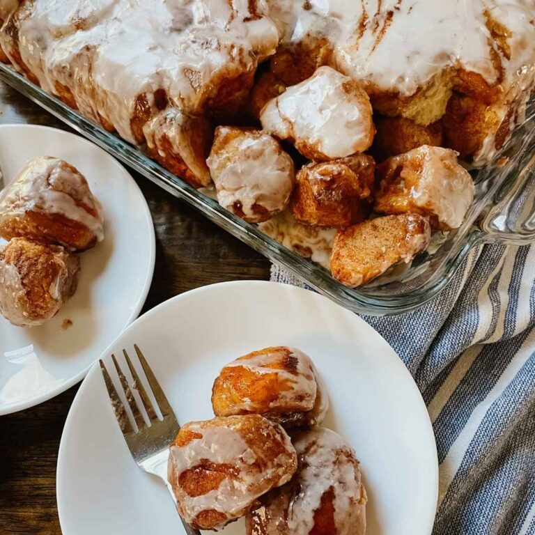 Sourdough brown butter monkey bread in pan and on white plate with a fork
