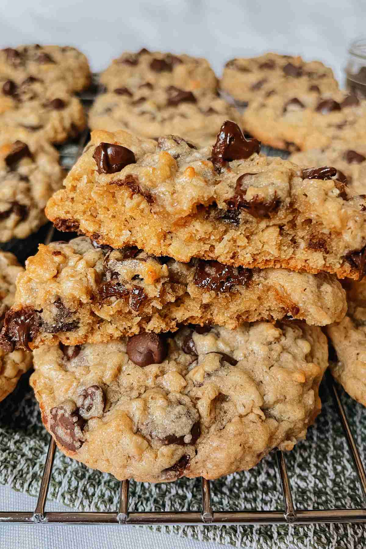 Sourdough peanut butter oatmeal chocolate chip cookies stacked to show chewy center