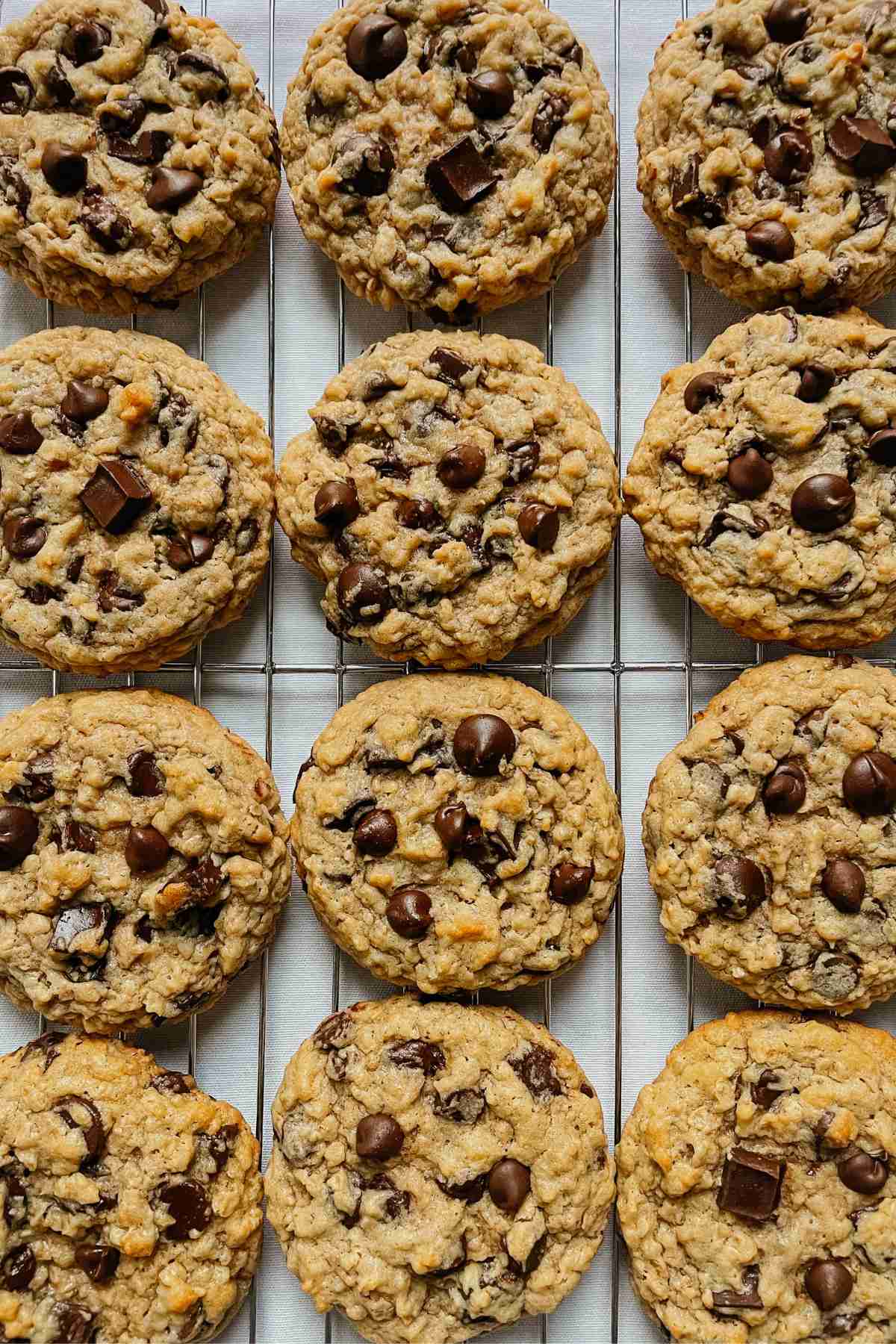 Sourdough peanut butter oatmeal chocolate chip cookies on wire rack