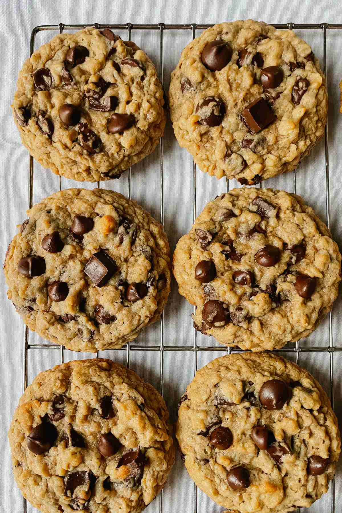 Sourdough peanut butter oatmeal chocolate chip cookies on wire rack